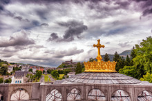 Christian Gold Cross On The Roof Of The Basilica Of Our Lady Of The Rosary In Lourdes, France