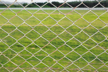 wire mesh steel with green grass background in Phuket Thailand