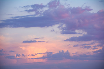 Background of a pink and purple sky at sunset.