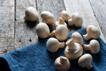 Wall Mural - Champignon mushrooms on wooden background