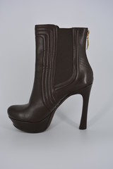 Brown women's stylish autumn boots made of genuine leather with high and thin heels.