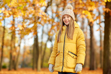 Poster - childhood, season and people concept - happy girl at autumn park