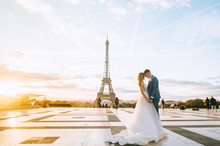 Happy Romantic Married Couple Hugging Near The Eiffel Tower In Paris
