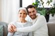 © Syda Productions - family, generation and people concept - happy smiling senior mother with adult son hugging at home