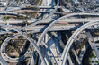 Afternoon aerial view of ramps and traffic on the Harbor 110 and Century 105 freeway junction in Los Angeles County, California.  