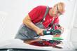 © Kadmy - auto mechanic buffing car autobody