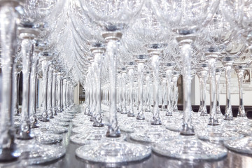 Many rows of empty wine glasses on the table by macro shooting