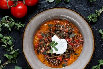 Wall Mural - dish of purslane. potulak-edible useful weed. stalks of purslane stewed with tomatoes. Turkish, Greek, Mexican cuisine. eat the weeds, wild food. Omega-3