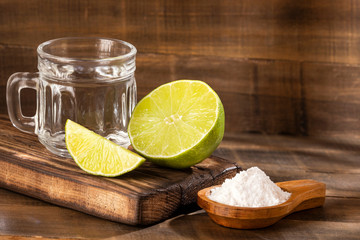 Wall Mural - Glass of water, lemon, soda bicarbonate - Citrus × latifolia. Text space