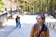 Young smiling happy woman, caucasian foreigner traveler walking in Nikko, Japan on street road by forest in spring
