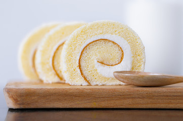 Vanilla roll cake on wood tray