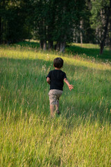 little boy running in the field