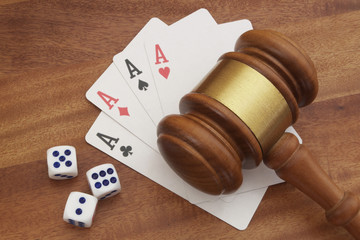 Dices, cards and  judge gavel on wooden table