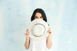 © Pixel-Shot - Portrait of beautiful woman with hat on light background