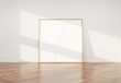 Wooden frame leaning in bright white interior with wooden floor mockup 3D rendering