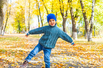 Wall Mural - boy fooling around on a walk in autumn