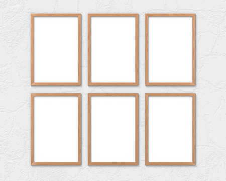 Set of 6 vertical wooden frames mockup with a border hanging on the wall. Empty base for picture or text. 3D rendering.
