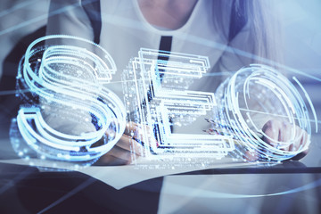 Double exposure of woman's hands making notes with SEO icon. Concept of Search engine optimization