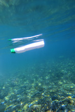 Plastic Bottle Floating In The Sea, Photo Underwater With The Seabed