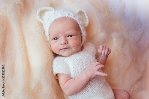Portrait Of A Newborn Baby With Open Eyes In A Polar Bear Costume