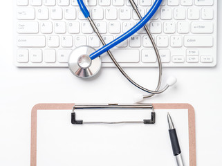 Wall Mural - Medical Concept - Stethoscope on computer keyboard on white background. Physician long term care treatment concept. Top view, flat lay, copy space