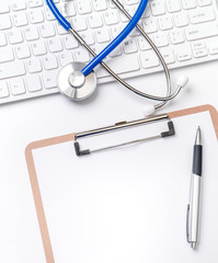 Wall Mural - Medical Concept - Stethoscope on computer keyboard on white background. Physician long term care treatment concept. Top view, flat lay, copy space