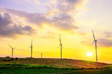 Landscape mountain view with windmills on the hill with sunset sky, Wind turbine generator to build electricity power in rural area, Electricity power concept