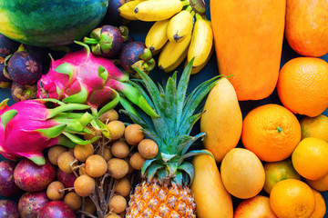 set fresh organic exotic tropical fruit on dark