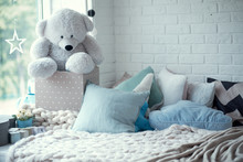 Cozy Children's Room In Bright Soft Colors, Pillows And A Blanket Are Lying On The Bed