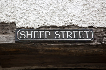 Wall Mural - Sheep Street Road Sign on Stone Wall; England