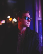 Man Wearing Black Sunglasses Looking At His Left Side In Bokeh Photography