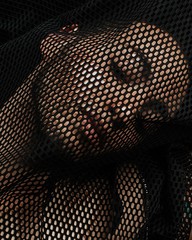 person under mesh black textile