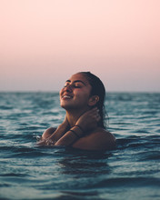 Woman Holding Her Neck In Body Of Water