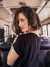 Woman In Black Top Standing Inside The Bus During Daytime