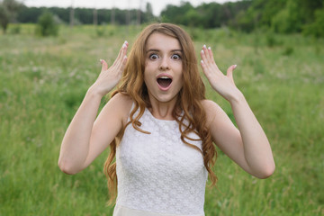 Beautiful young girl shows joy in nature