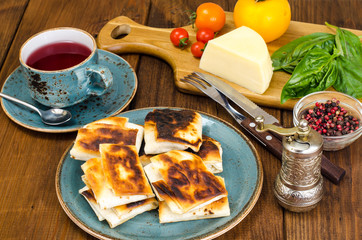 Wall Mural - Fried pita bread filled with cheese, tomato and greens