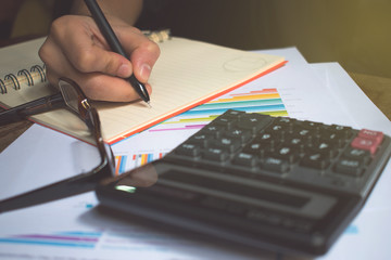 Poster - Asian, A man wearing a black shirt, putting glasses over the book, a record number. Derived from the calculator.