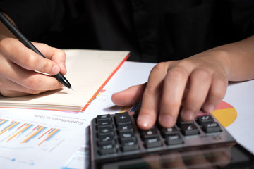 Poster - A man hand holding a pen and a record number from the calculator.