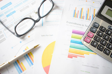 Poster - A desk with graphs and numbers. Close up
