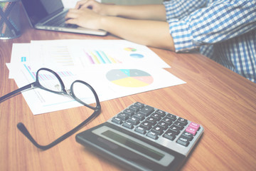 Poster - The man's hand is wearing a blue plaid shirt is working seriously on desk. Business Concepts