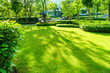 © singjai - The sunshine in the evening shines through the trees down to the lawn of the front of the house beautifully, green lawn, Front lawn for the background, designed a beautiful shady landscape garden.
