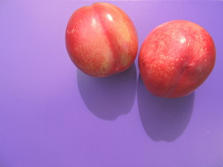 sweet and juicy nectarine on blue background.