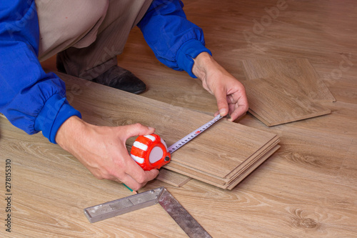 Man Measures The Laminate Floorboard Measuring The Laminate Board