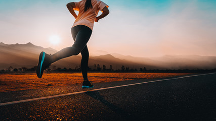 woman enjoys running outside with beautiful summer evening in the countryside.