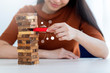 business creativity and strategy ideas concept smart beautiful asian woman try to built wooden block tower to stable and successful white background