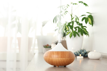 composition with modern essential oil diffuser on wooden shelf indoors, space for text