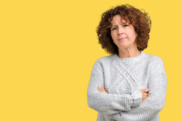 Sticker - Beautiful middle ager senior woman wearing winter sweater over isolated background skeptic and nervous, disapproving expression on face with crossed arms. Negative person.