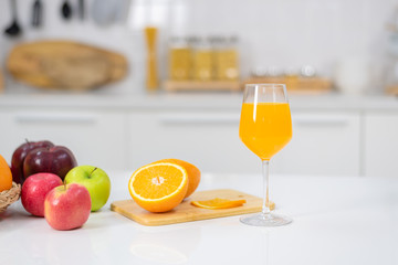 Orange juice is placed on a white table, orange juice, bright colors placed on the table and the atmosphere in the kitchen is clean white.