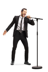 Canvas Print - Man in a suit singing on a microphone