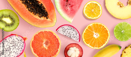 Fotomural Creative layout made of papaya, grapefruit, lemon, kiwi, melon, watermelon, banana, pineapple, orange, mangosteen and flowers on pink background